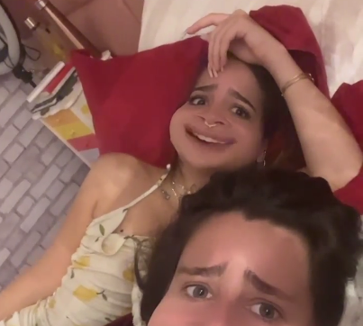 Mel Maia quase exibindo os seios na cama com amiga